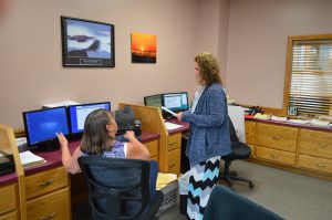 Two women looking at computers at a desk